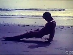 Beautiful vintage boy wanders the beach in the nude
